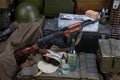 Kalashnikov AK 47 with ammunitions and vodka on army box background