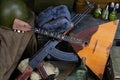 Kalashnikov AK 47 with ammunitions, vodka and balalaika on army box background Royalty Free Stock Photo