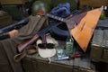 Kalashnikov AK 47 with ammunitions, vodka and balalaika on army box background Royalty Free Stock Photo