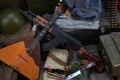 Kalashnikov AK 47 with ammunitions and vodka on army box background