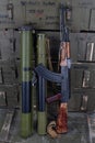 Kalashnikov AK47 gun and `Bazooka` RPG grenade launchers in army green crate