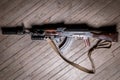 Kalashnikov assault rifle with modern accessories  on wooden background Royalty Free Stock Photo