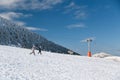 Kalavrita ski Resort, Greece - December, 31 2019: Two happy girls running down in snowy slope enjoying winter holidays Royalty Free Stock Photo