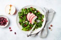 Kale salad with dried cranberry, hazelnuts and sliced apple.