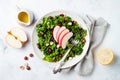 Kale salad with dried cranberry, hazelnuts and sliced apple.