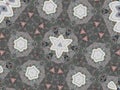 Kaleidoscope pattern with flower-shaped figures in gray and white