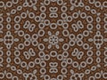 Kaleidoscope with small whitish flowers on brown background