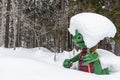 Kali the Ramsaurier, likeable, snow covered, green dinosaur mascot of ski school at ski region Ramsau Dachstein, Steiermark.