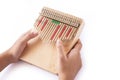 hands holding and play Kalimba  Mbira or thumb piano   on white . Royalty Free Stock Photo