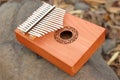 Kalimba or Hand Piano on stone and dry leaves background. Kalimba an African musical Instrument on Rock