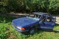 Wrecked old car. Abandoned car. Stolen car. Mitsubishi blue. Passenger car