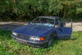 Wrecked old car. Abandoned car. Stolen car. Mitsubishi blue. Passenger car Royalty Free Stock Photo