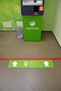 An ATM and sticker on the floor `# save yourself and other 1.5 m.` Sberbank premises during the Coronavirus Epidemic COVID-19