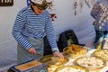 Kaliningrad, Russia - April 13, 2019: Woman cooking sweets on holiday of herring day