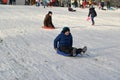 KALININGRAD, RUSSIA. Boys ride from a hill the plastic sledge