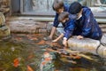 KALININGRAD, RUSSIA. Children in protective masks play with colored carps in the pavilion of the zoo. Coronavirus epidemic period Royalty Free Stock Photo