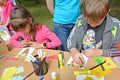 The boy and the girl do applique of color paper. Children`s master class in the open air