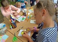 KALININGRAD, RUSSIA. Children do applique of color paper. Children`s master class in the open air