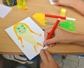 The children`s hand paints paper applique. Children`s master class