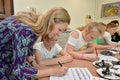 Class in a calligraphy with the teacher in children`s studio Royalty Free Stock Photo