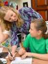 KALININGRAD, RUSSIA. The joyful teacher and the schoolgirl on occupation a calligraphy in children`s studio