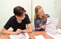 KALININGRAD, RUSSIA. The teacher shows to the teenager writing of letters. Occupation a calligraphy in the developing center Royalty Free Stock Photo