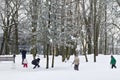 KALININGRAD, RUSSIA - MARCH 19, 2016: Unknown family, parents and their children, play in snowballs in a city park in the center