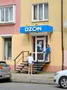 KALININGRAD, RUSSIA - MAY 04, 2021: Buyer and employee of the OZON online store issue point talk at the entrance