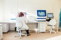 Kaliningrad, Russia october 15 2019. Scientist woman in a white coat working in biological or medical lab with DNA analyzer, Royalty Free Stock Photo