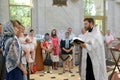 KALININGRAD, RUSSIA. Orthodox priest reads prayer during baptism rite