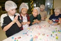Children sculpt figures from a pastry mastic. Children`s workshop at the chocolate