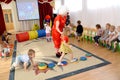 The clown-animator conducts the child on a touch path. Cheerful relay in younger group