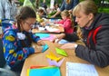 KALININGRAD, RUSSIA. The girl puts origami. Children`s master class in the open air