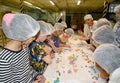 A group of schoolchildren sculpt figures from a pastry mastic. Children`s workshop at the chocolate factory