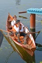 KALININGRAD, RUSSIA. The man and the woman in national suits sit floats in the boat. Holiday Water Assembly