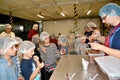 Master puts chocolate mass into cups for tasting. Children `s tour to the Belgostar chocolate factory