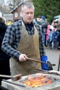 KALININGRAD, RUSSIA.The smith holds a poker over a forge brazier