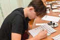 KALININGRAD, RUSSIA.The young man is engaged in a calligraphy in studio Royalty Free Stock Photo