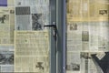 Editorial - closed door of small business with old newspapers on it