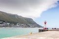 Recreational pier with beacon built in 1919 and fishermen at Kalk Bay harbour near Cape Town South Africa