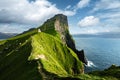 Kallur lighthouse on green hills of Kalsoy island