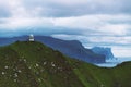 Kallur lighthouse on green hills of Kalsoy island Royalty Free Stock Photo