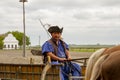 Portrait of Hungarian Csikos horseman in cart