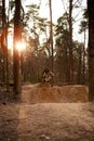 Cyclists in the forest on a track with slides for sport mountain Biking. Mountain bike jumping, extr