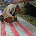 Kaluga, Russia November 1, 2019: mineral wool in the attic, work with waterproofing material, waterproofing film for the attic