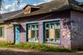 Kaluzhskiy Region, Russia - August 2019: Old brick building painted in purple and with broken windows