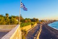 Kamari black beach and Greek flag waving Santorini Greece Royalty Free Stock Photo