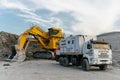 Kamaz service vehicle in the open pit. A Komatsu PC4000 excavator can be seen in the background. The excavator is being serviced.