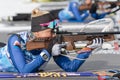 Kamchatka sportswoman biathlete Kseniya Petrunova rifle shooting in prone position. Biathlete in shooting range of Open