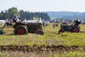 Plowing vintage veteran tractors on field on ploughing championship Royalty Free Stock Photo